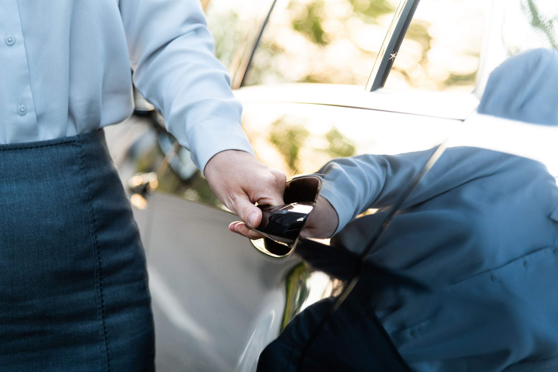 Well dressed woman opening a car door